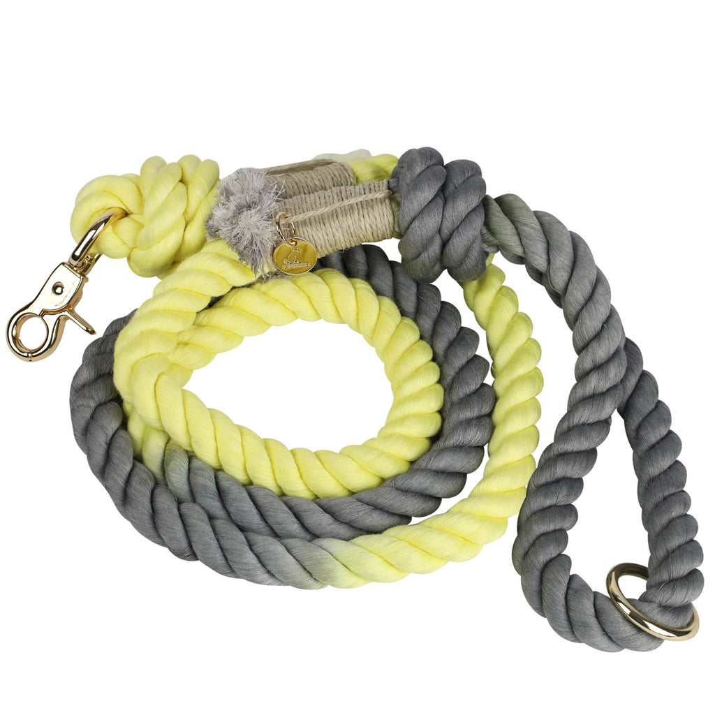 Handmade and hand-dyed butter yellow and gray cotton rope dog leash coiled with gold hardware clasp, O-ring, and Puppysentials charm, showing durable and stylish design.