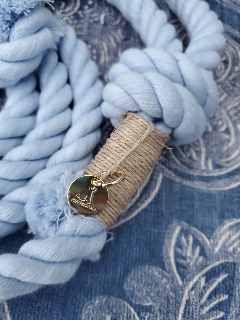 Coiled light blue cotton rope dog leash featuring Puppysentials gold charm — handcrafted soft rope dog leash for medium to large dogs.